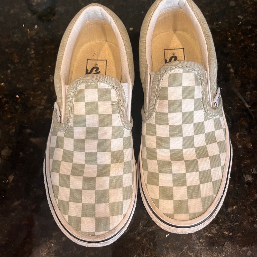 Greenish boy slip on vans.